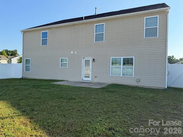 a backyard of a house with lots of plants and space