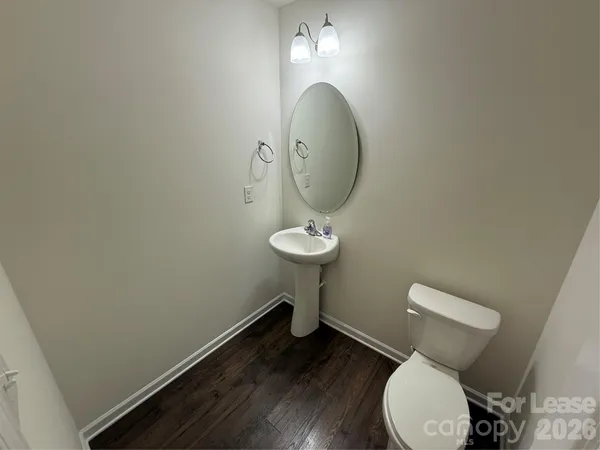 a bathroom with a toilet and a mirror