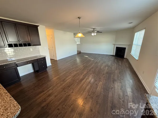 a view of a kitchen with wooden floor and stove