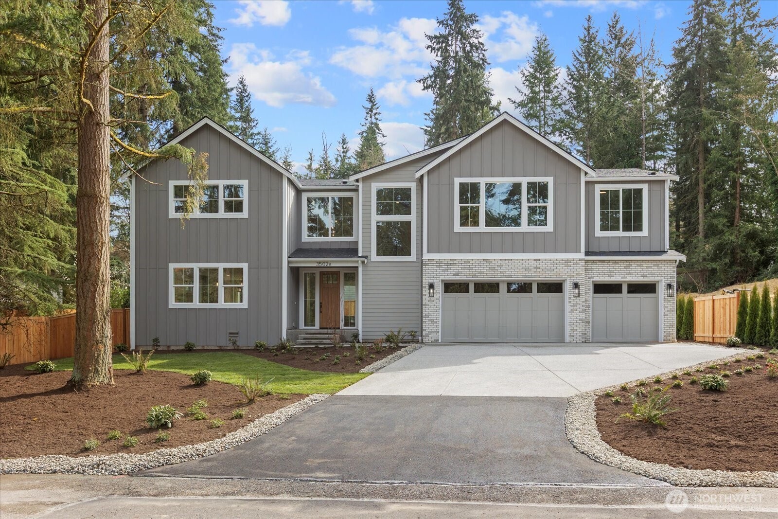 a front view of a house with a yard and garage