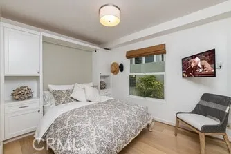 a bedroom with a bed and a painting on the wall