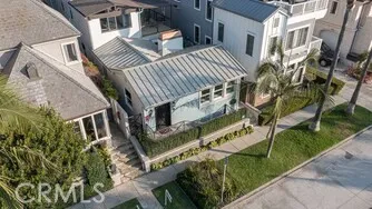a view of a house with a yard and potted plants