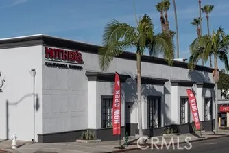 a front view of a building with palm tree