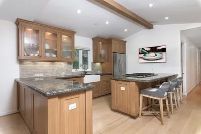 a kitchen with stainless steel appliances granite countertop stove top oven and cabinets
