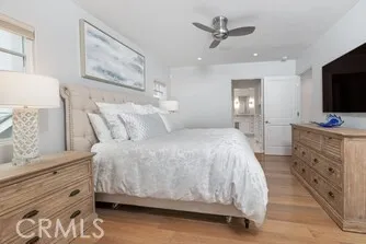 a spacious bedroom with a bed and a flat screen tv