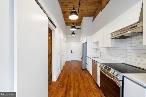 a kitchen with stainless steel appliances granite countertop a stove and a sink