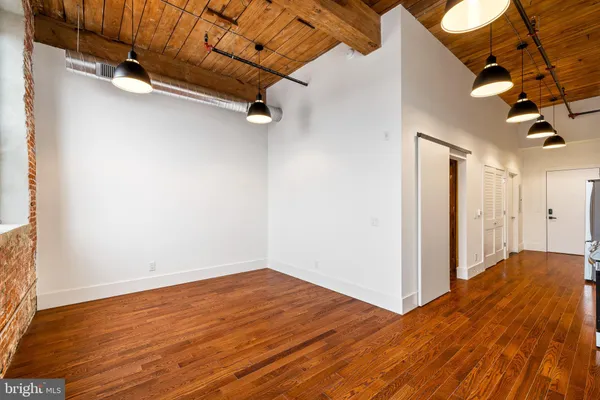 a view of a room with wooden floor