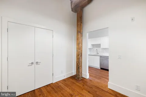 a view of a room with wooden floor and a sink