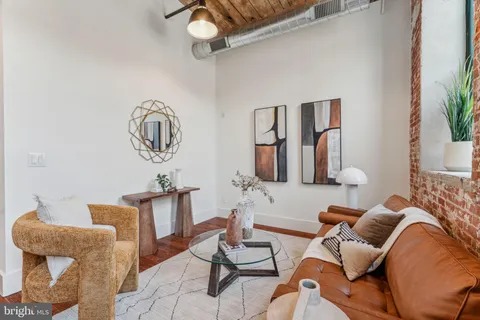 a living room with furniture and potted plant