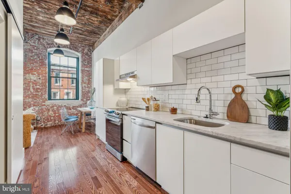 a kitchen with sink a stove and cabinets
