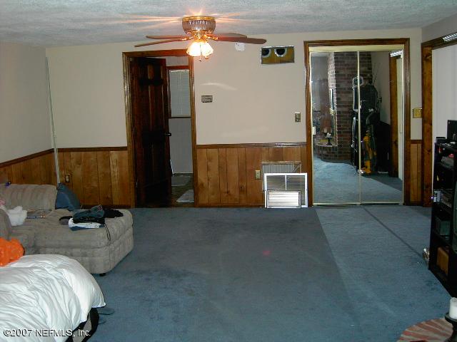 1201 Hibiscus Street St. Augustine, FL 32084 - Photo 12 of 16 a living room with furniture and a ceiling fan