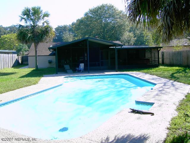 1201 Hibiscus Street St. Augustine, FL 32084 - Photo 3 of 16 a backyard of a house with lots of green space