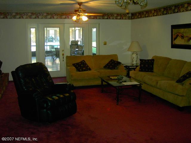 1201 Hibiscus Street St. Augustine, FL 32084 - Photo 4 of 16 a living room with furniture and a chandelier