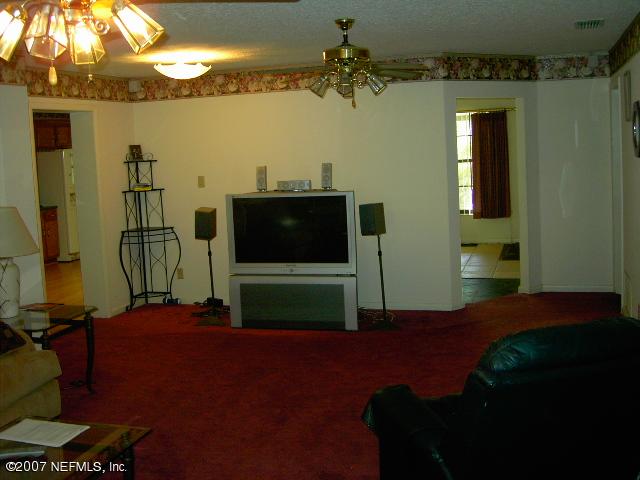 1201 Hibiscus Street St. Augustine, FL 32084 - Photo 5 of 16 a bedroom with furniture and a flat screen tv