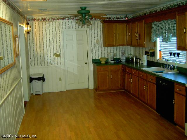 1201 Hibiscus Street St. Augustine, FL 32084 - Photo 9 of 16 a kitchen with a sink and cabinets