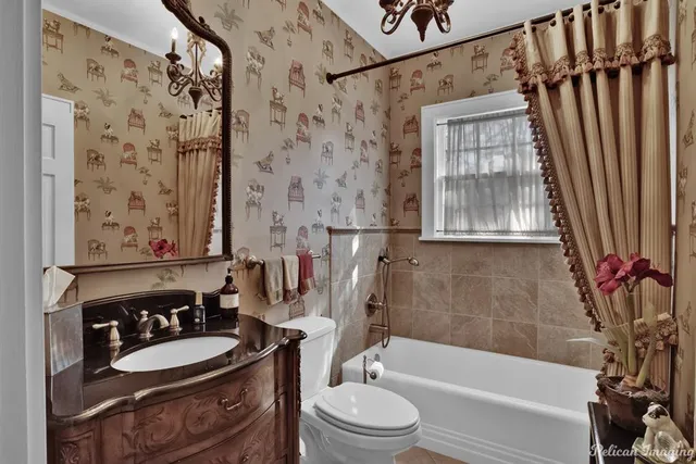 a bathroom with a granite countertop sink toilet a mirror a bathtub and shower