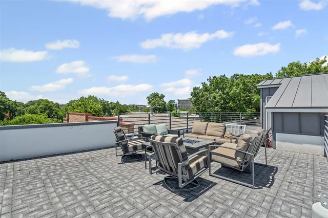 a balcony with furniture and a potted plant