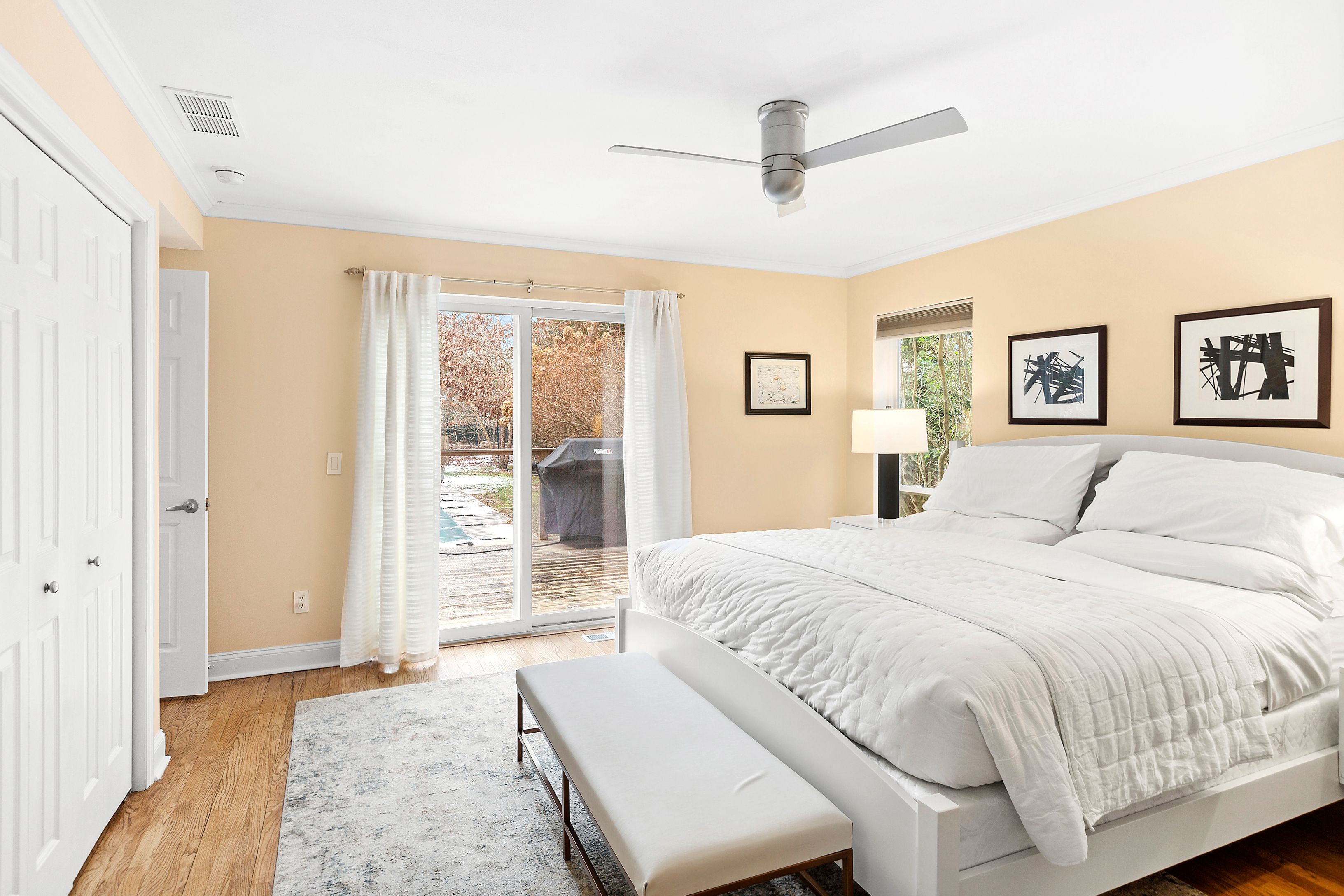 15 East East Gate Road Wainscott, NY 11975 - Photo 6 of 10 a spacious bedroom with a large bed and a window