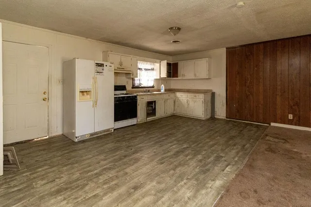 a kitchen with a refrigerator and a sink