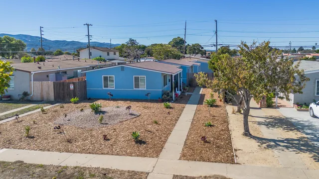 a view of a house next to a yard