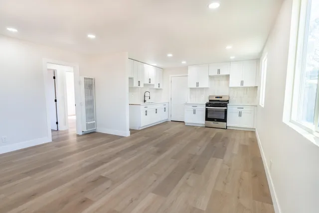 a view of kitchen with refrigerator stove microwave and cabinets