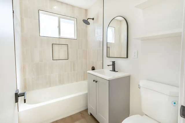 a bathroom with a sink a toilet and a bathtub
