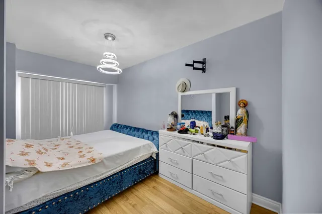 a bedroom with a bed and a chandelier