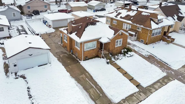 an aerial view of a house with a yard