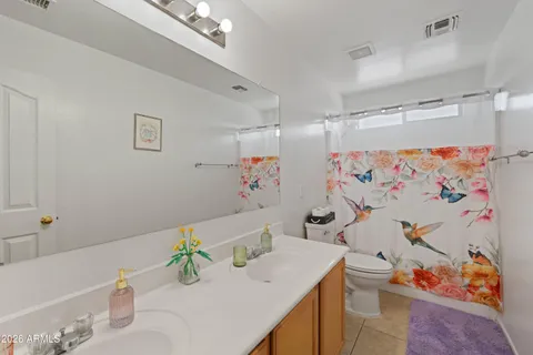 a bathroom with a sink a toilet and a shower curtain