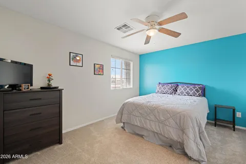 a bedroom with a large bed and a flat screen tv