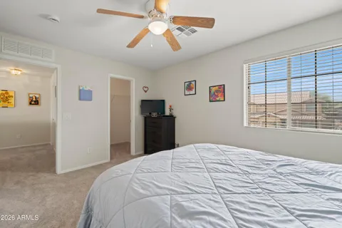 a bedroom with a large bed and a window