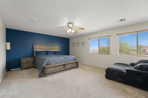 a bedroom with a bed and a couch