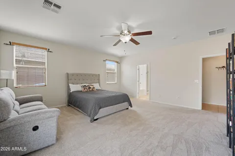 a bedroom with a bed couch and window