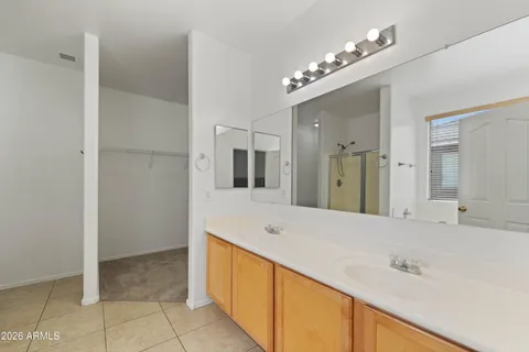 a spacious bathroom with a double vanity sink and a mirror