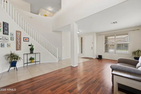 a living room with furniture and a wooden floor