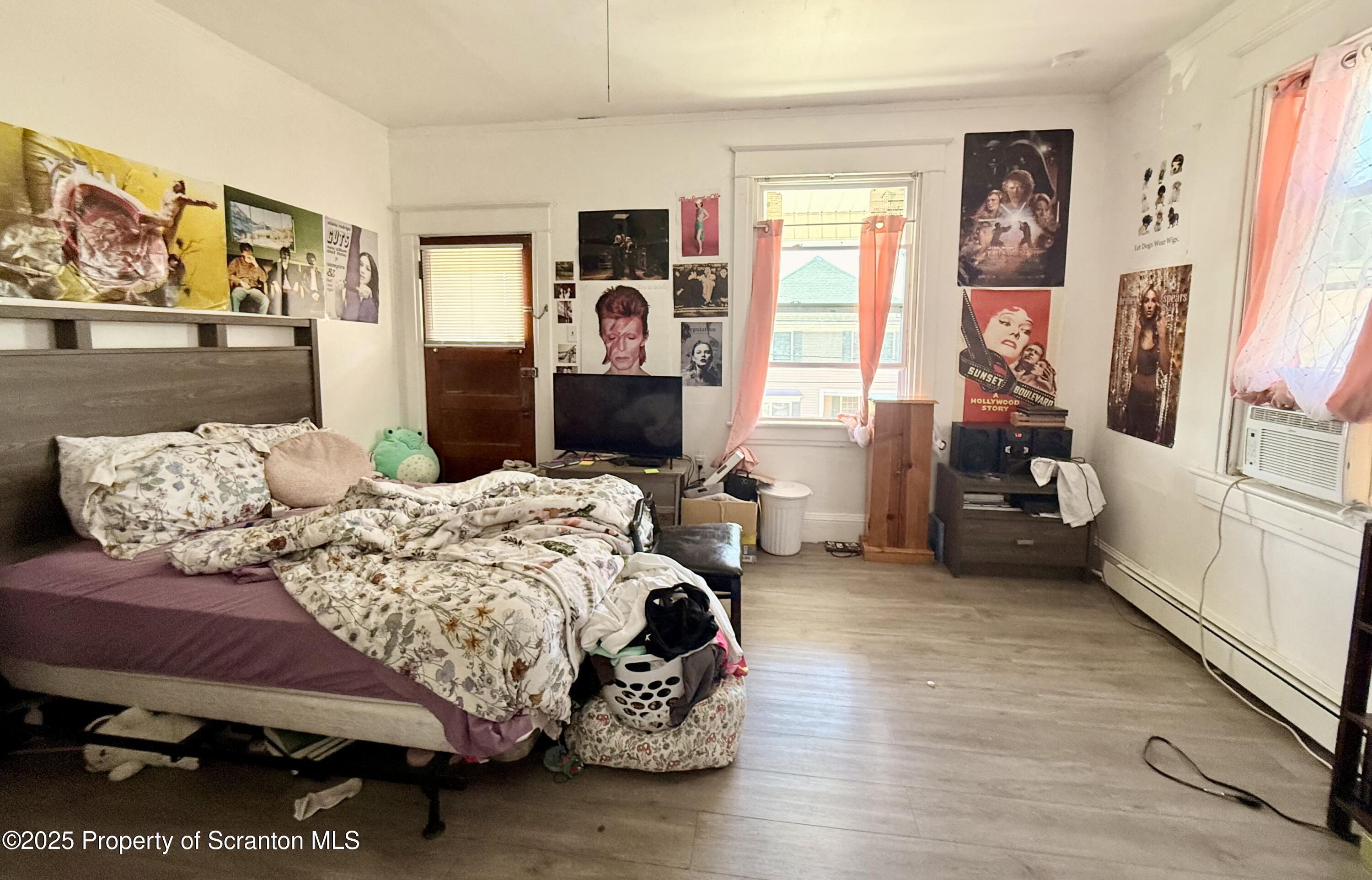 210 Mary Street Olyphant, PA 18447 - Photo 11 of 14 a bedroom with a bed and wooden floor