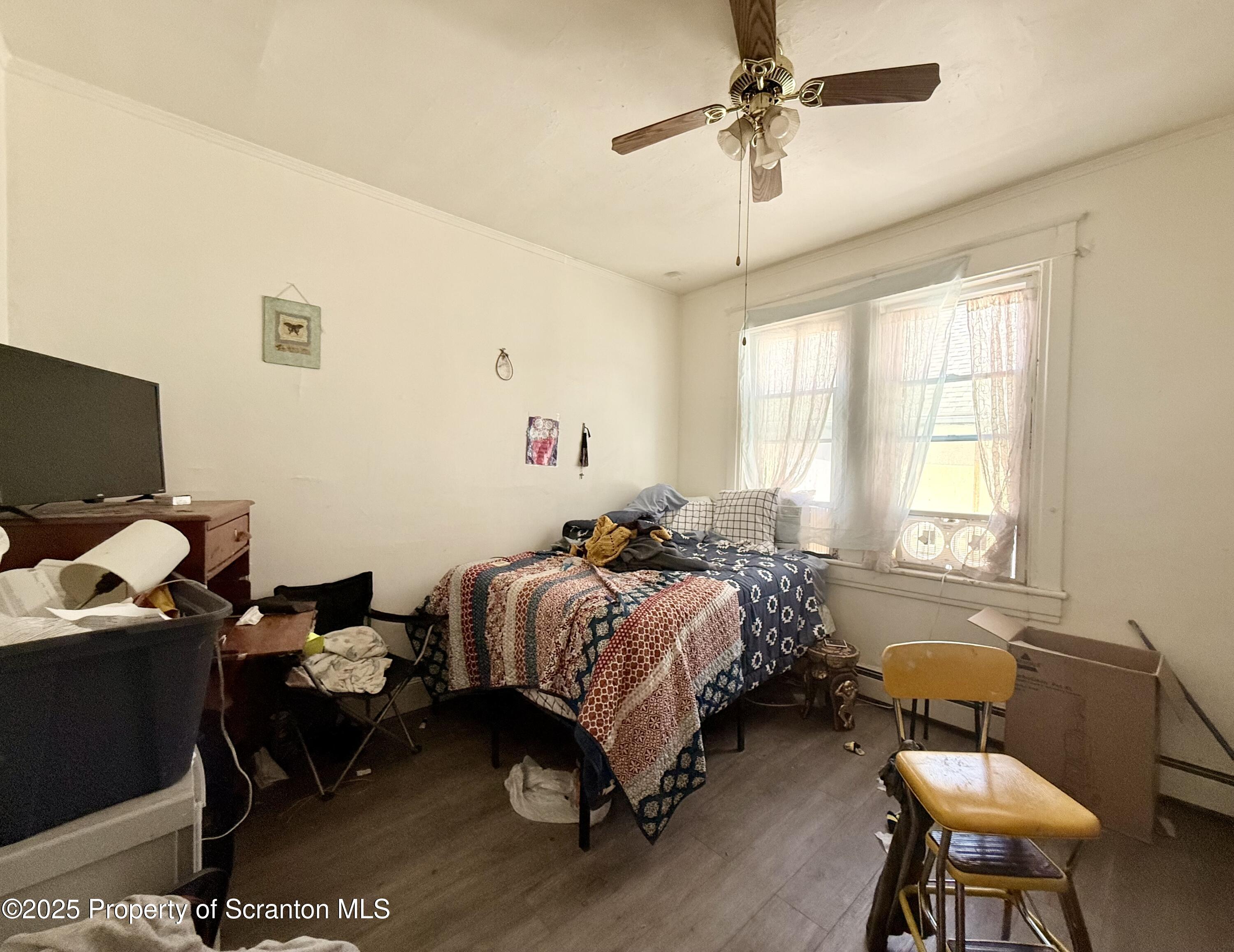 210 Mary Street Olyphant, PA 18447 - Photo 13 of 14 a bedroom with bed chair and window