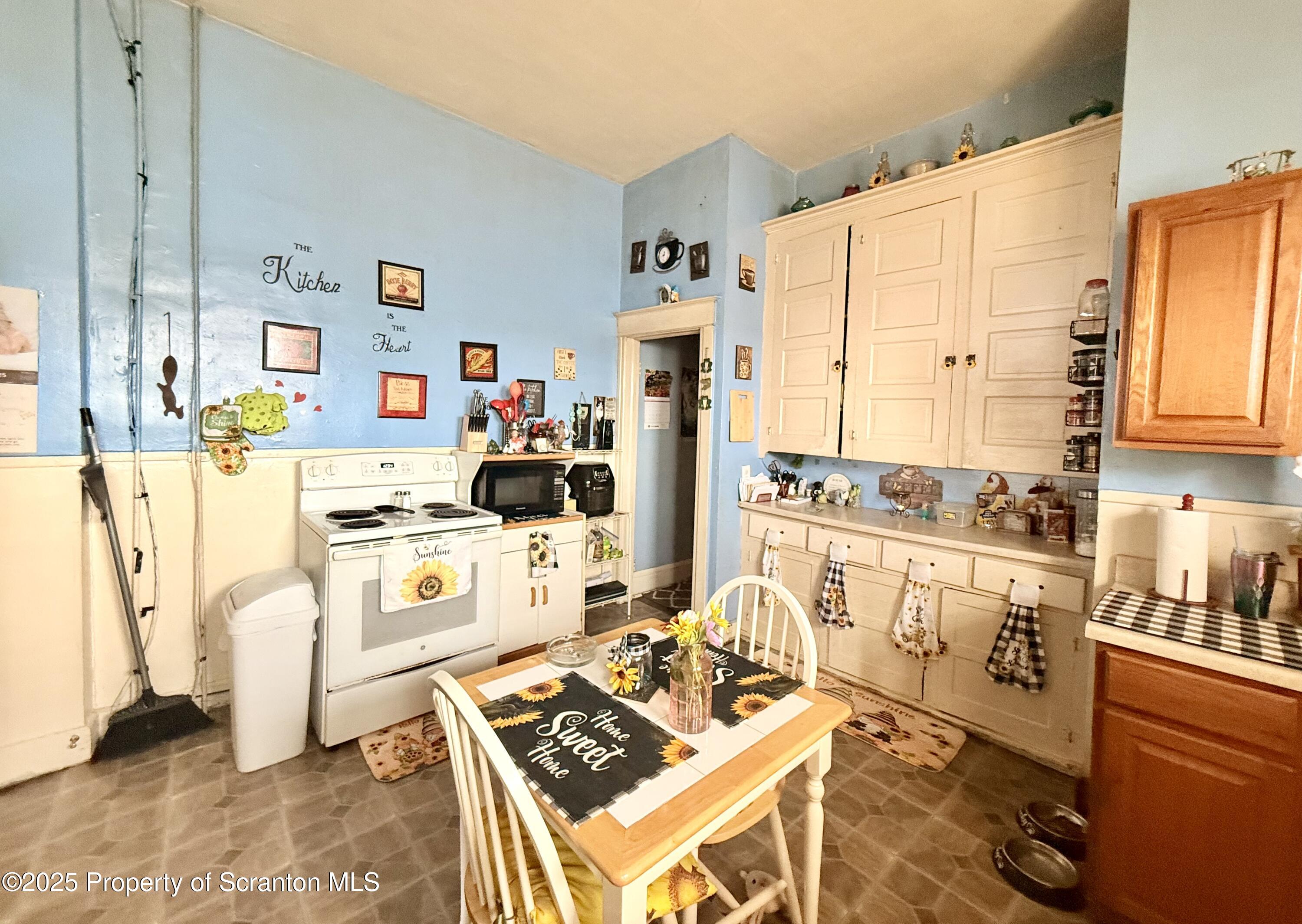 210 Mary Street Olyphant, PA 18447 - Photo 4 of 14 a kitchen with stainless steel appliances a stove a sink and a refrigerator