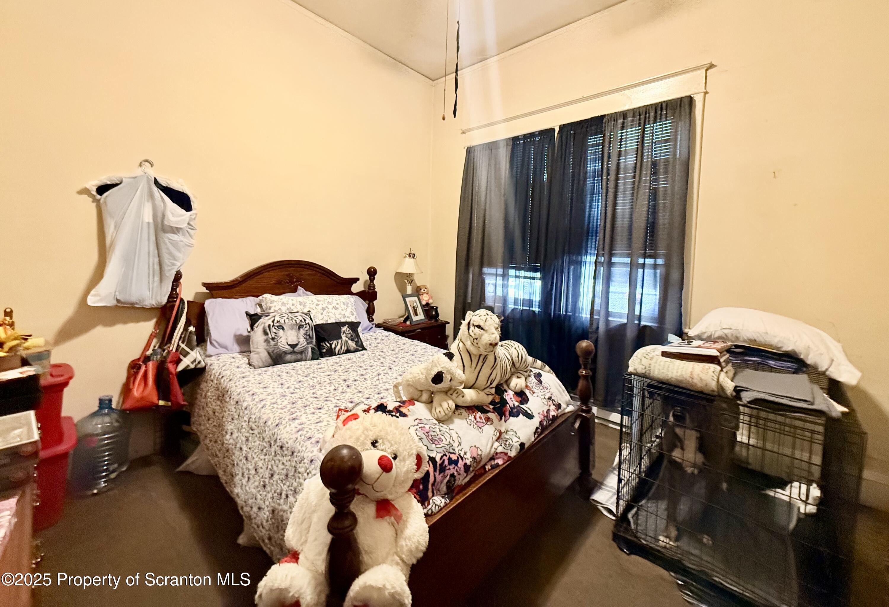 210 Mary Street Olyphant, PA 18447 - Photo 9 of 14 a bedroom with furniture and a window