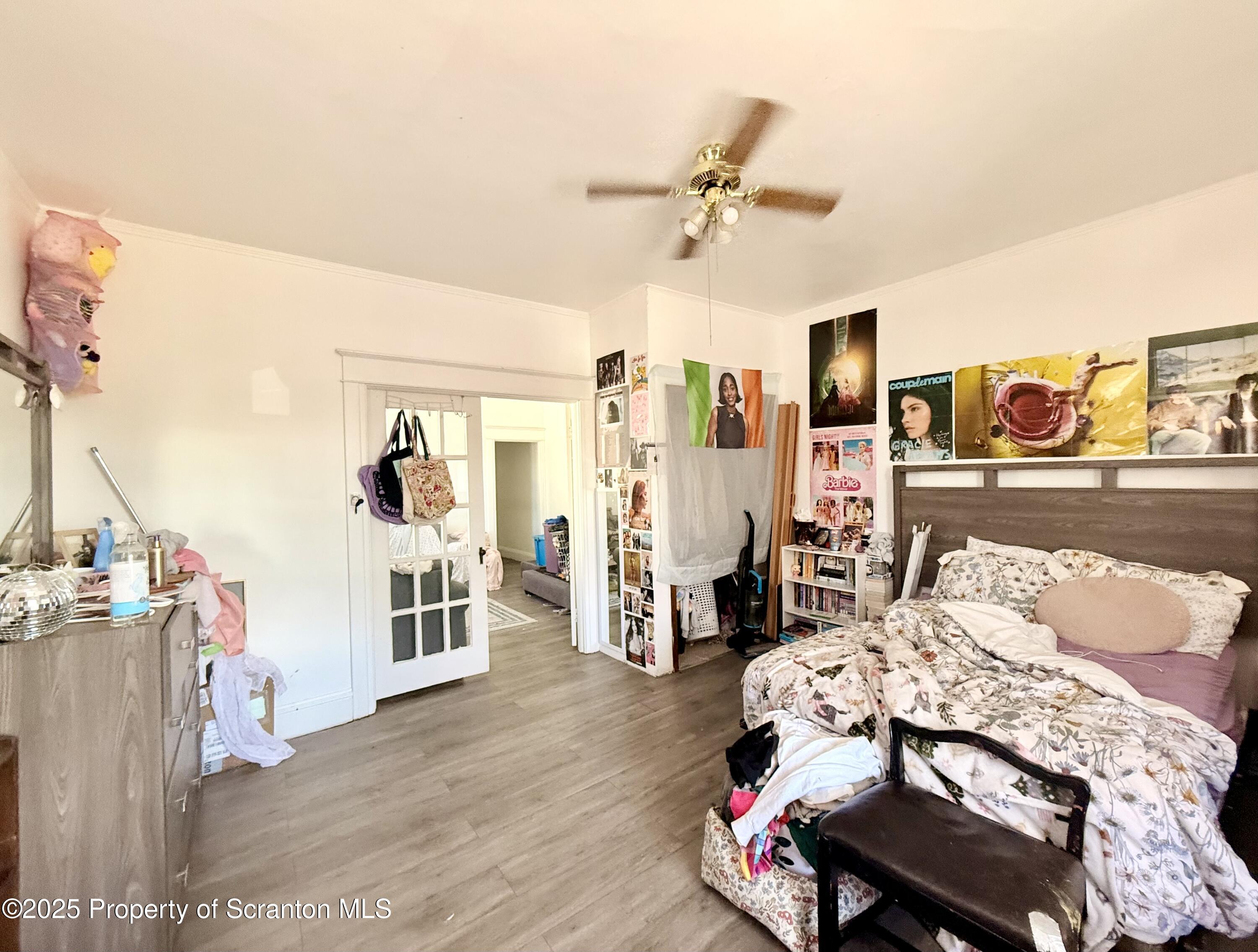 210 Mary Street Olyphant, PA 18447 - Photo 10 of 14 a bedroom with a bed a couch and dresser