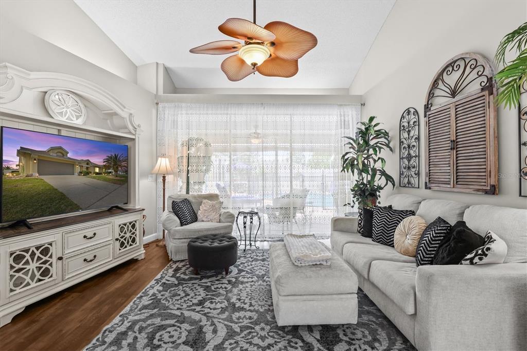 1049 Larkin Road Spring Hill, FL 34608 - Photo 15 of 64 a living room with furniture and a flat screen tv