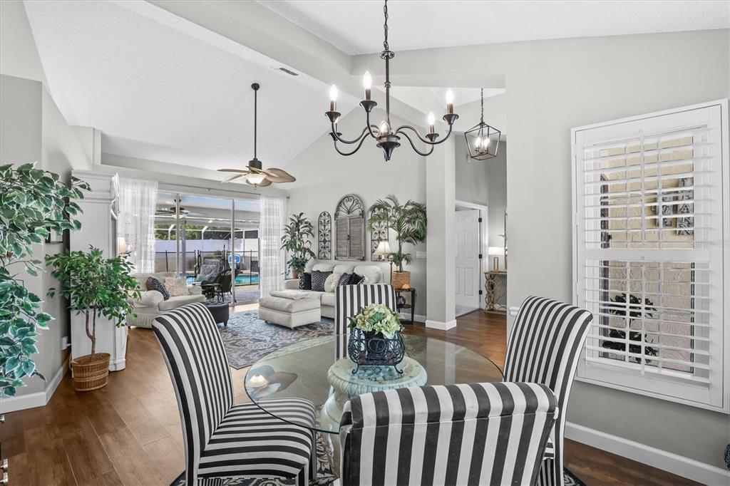 1049 Larkin Road Spring Hill, FL 34608 - Photo 19 of 64 a view of a dining room with furniture wooden floor and chandelier
