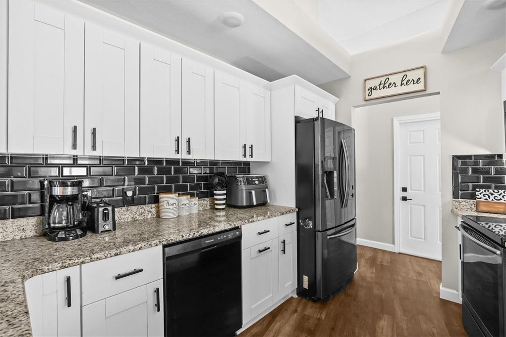 1049 Larkin Road Spring Hill, FL 34608 - Photo 22 of 64 a kitchen with stainless steel appliances granite countertop a refrigerator and stove