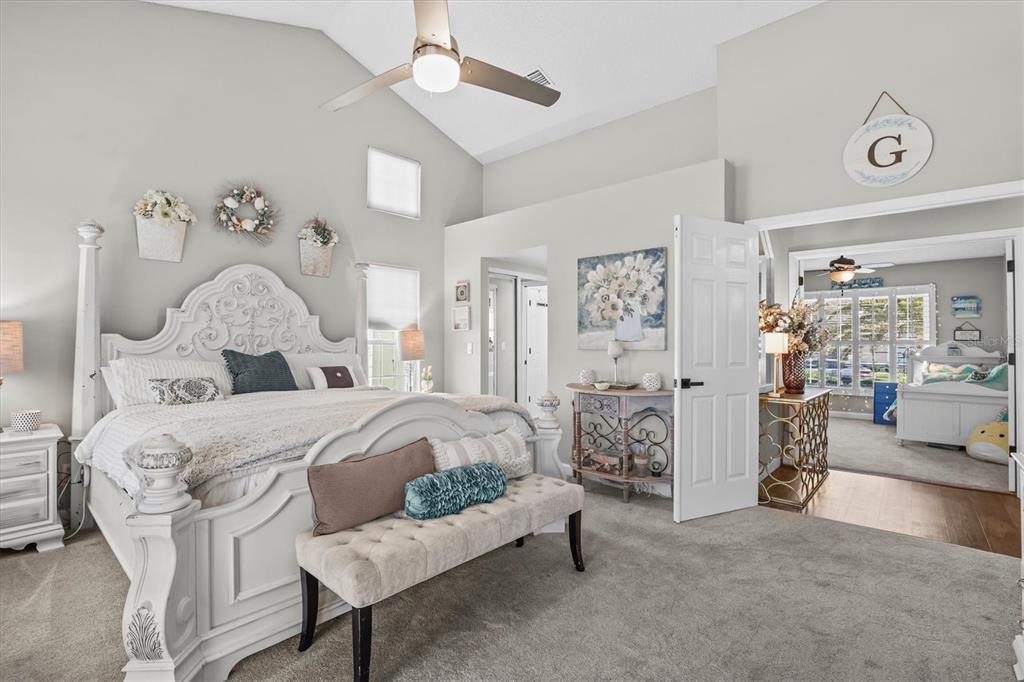 1049 Larkin Road Spring Hill, FL 34608 - Photo 33 of 64 a bedroom with a bed and a chandelier