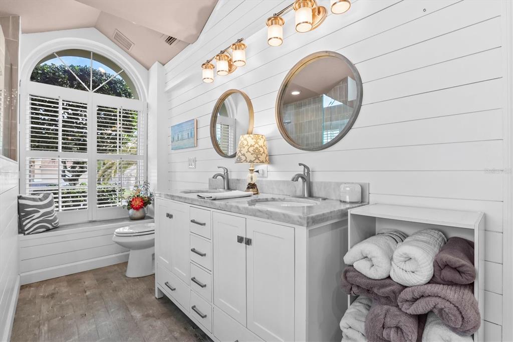 1049 Larkin Road Spring Hill, FL 34608 - Photo 35 of 64 a bathroom with a toilet a sink and a large mirror