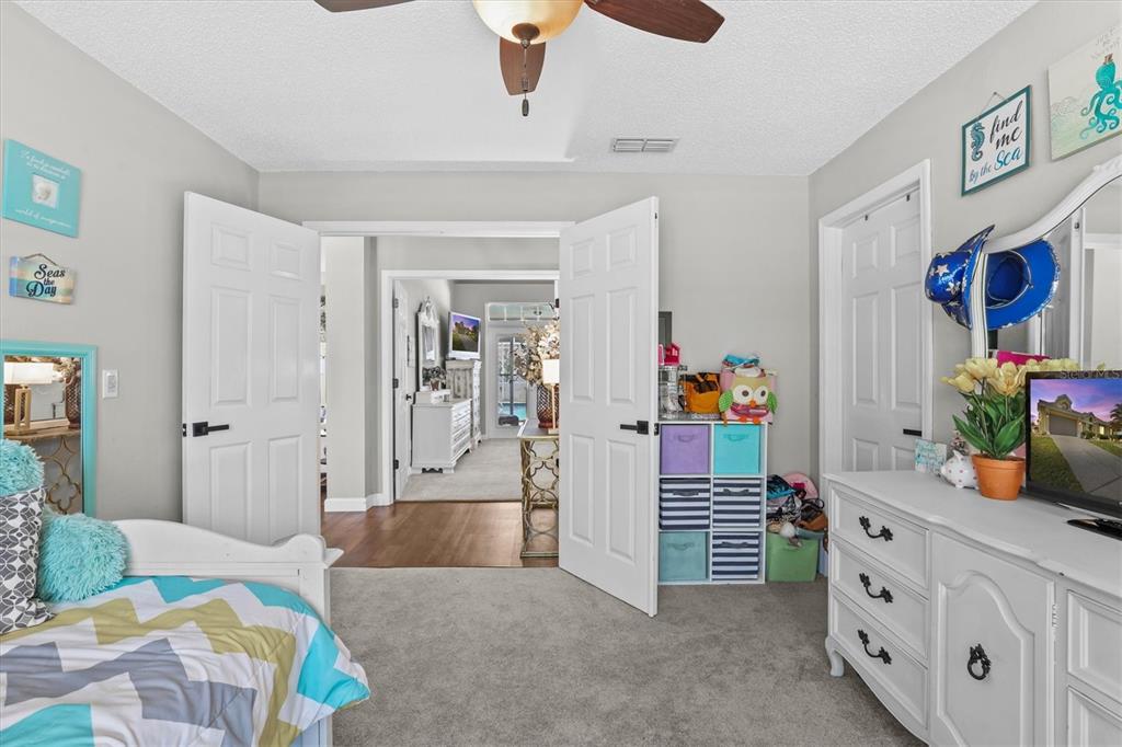 1049 Larkin Road Spring Hill, FL 34608 - Photo 40 of 64 a bedroom with furniture and a potted plant