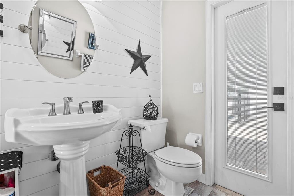 1049 Larkin Road Spring Hill, FL 34608 - Photo 41 of 64 a bathroom with a sink a toilet and a mirror