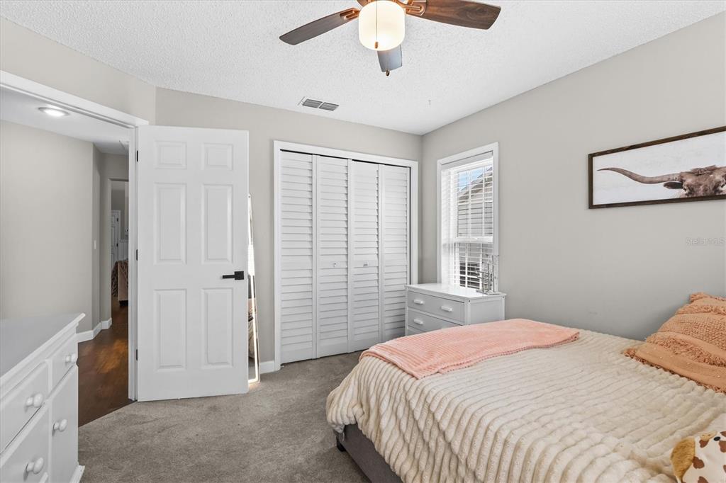 1049 Larkin Road Spring Hill, FL 34608 - Photo 45 of 64 a bedroom with a bed and a chandelier