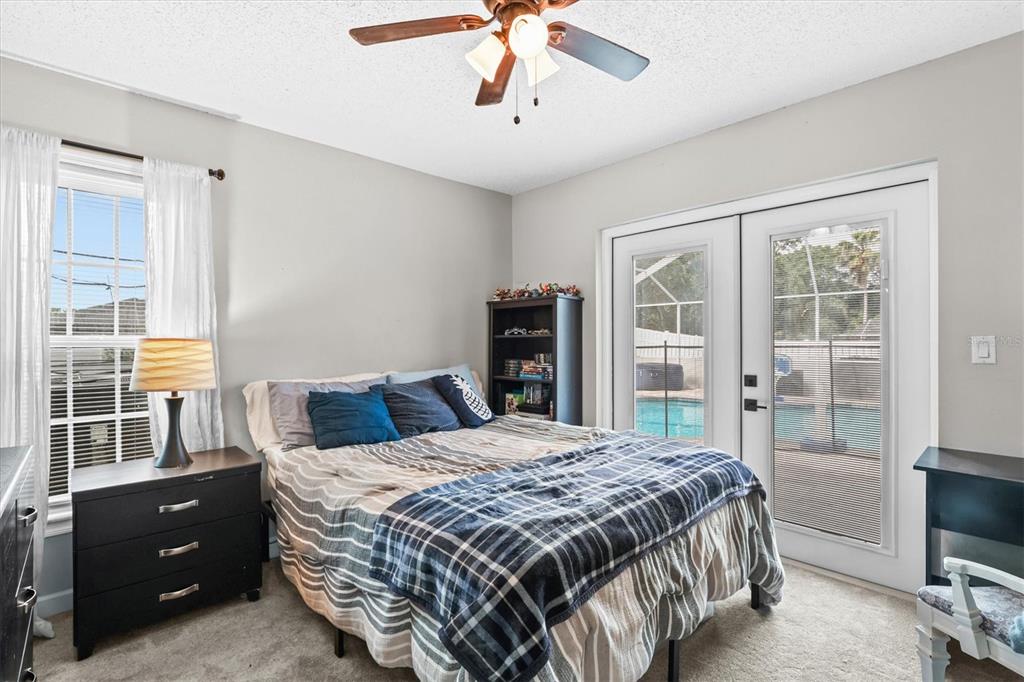 1049 Larkin Road Spring Hill, FL 34608 - Photo 46 of 64 a bedroom with a bed and a flat tv screen
