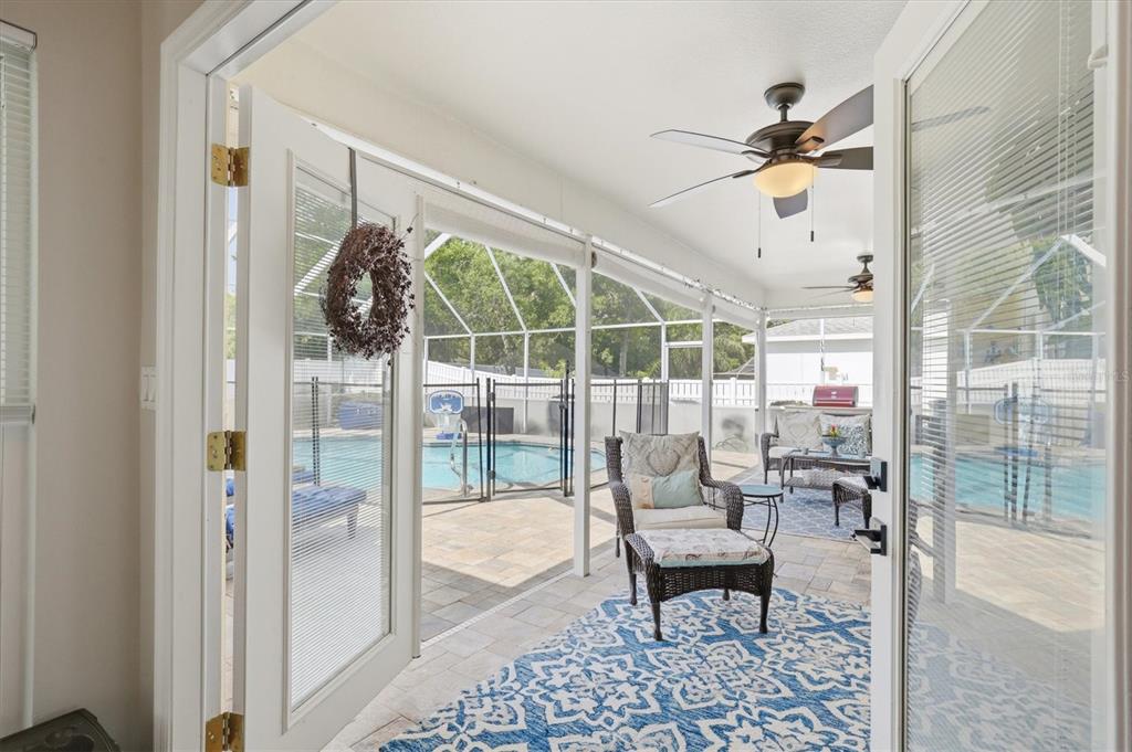 1049 Larkin Road Spring Hill, FL 34608 - Photo 48 of 64 a living room with furniture and a floor to ceiling window